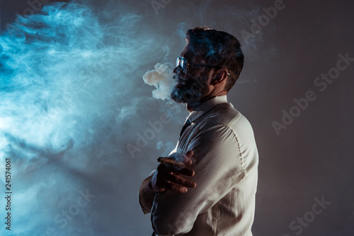 handsome bearded man smoking cigar