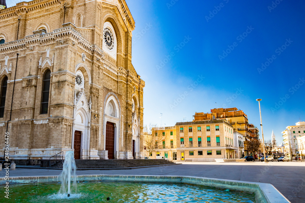 Cathedral of San Pietro Apostolo, also known as Duomo Tonti, by Paolo Tonti, who donated his wealth for its construction. Facade, rose windows, portals, dome and fountain. Cerignola, Puglia, Italy.