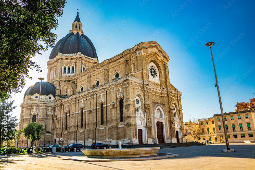 Fototapeta premium Cathedral of San Pietro Apostolo, also known as Duomo Tonti, by Paolo Tonti, who donated his wealth for its construction. Facade, rose windows, portals, dome and fountain. Cerignola, Puglia, Italy.