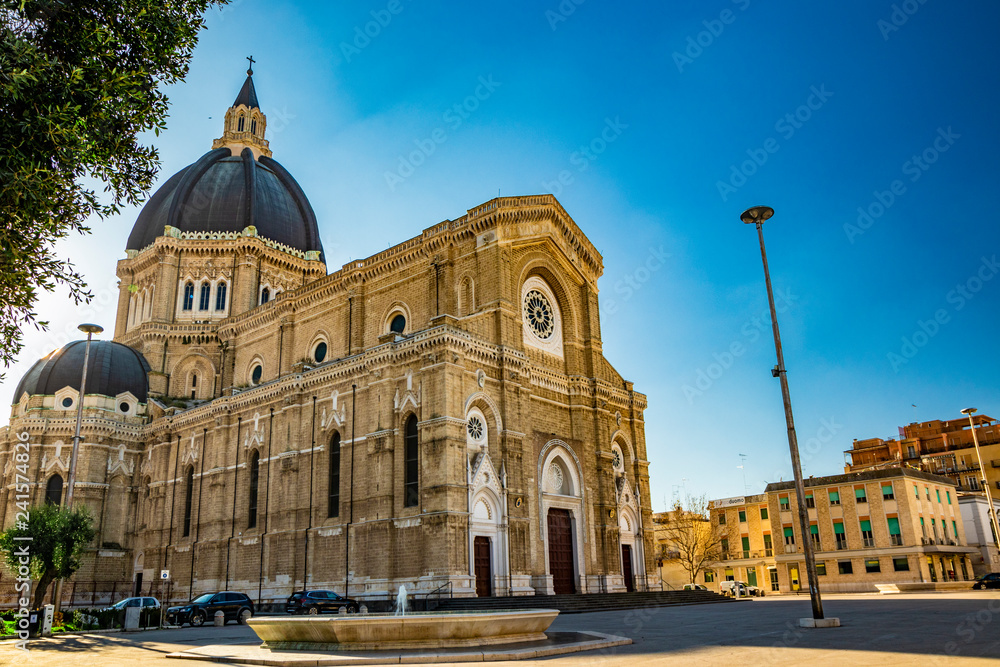 Fototapeta premium Cathedral of San Pietro Apostolo, also known as Duomo Tonti, by Paolo Tonti, who donated his wealth for its construction. Facade, rose windows, portals, dome and fountain. Cerignola, Puglia, Italy.