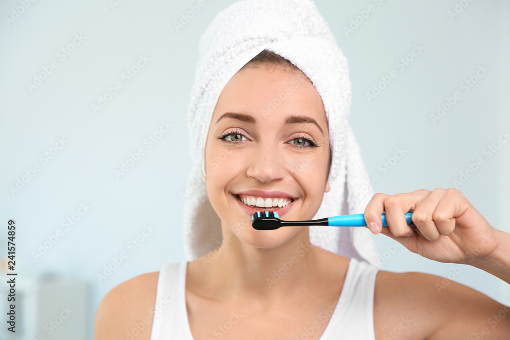 Portrait of young woman with toothbrush on blurred background Portrait of young woman with toothbrush on blurred background