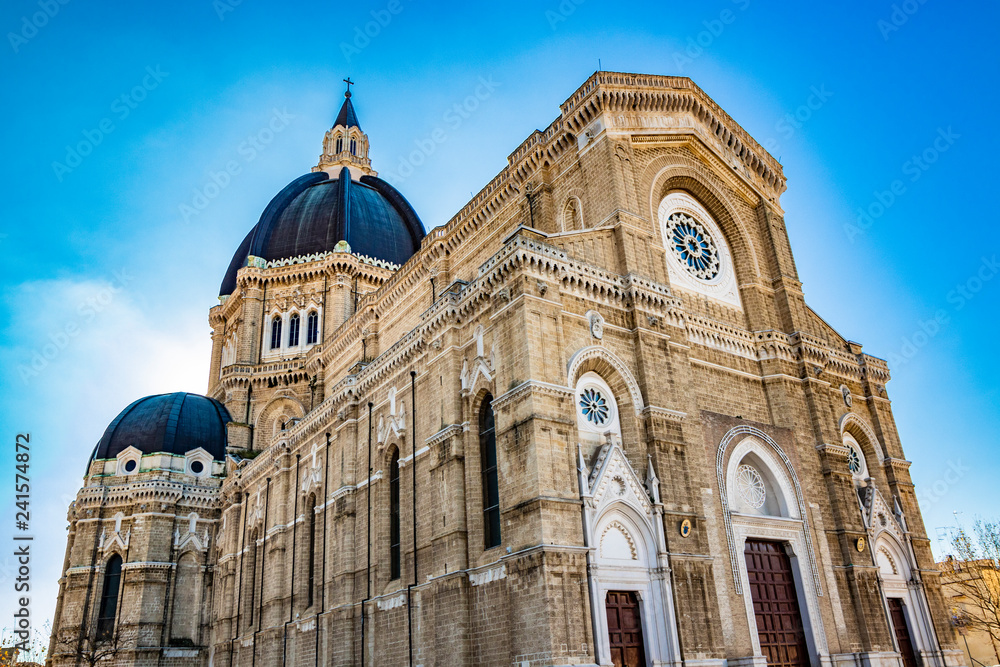 Cathedral of San Pietro Apostolo, also known as Duomo Tonti, by Paolo Tonti, who donated his wealth for its construction. Facade, rose windows, portals, dome and apse. Cerignola, Puglia, Italy.