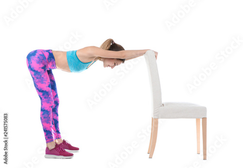 Young woman exercising with chair on white background. Home fitness © New Africa