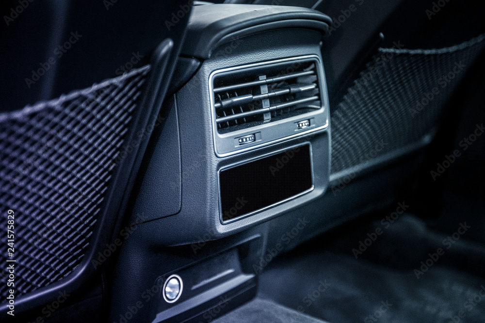 Close up of air conditioning system in car with leather interior