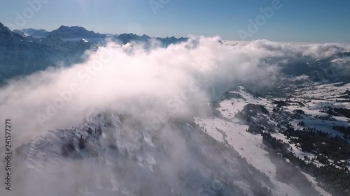 a drone flight in the Swiss mountains through the fog