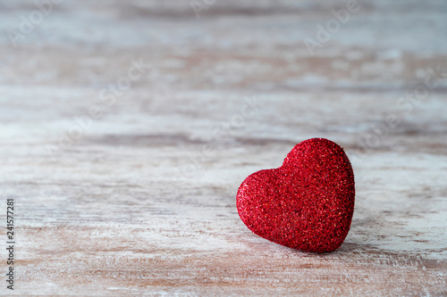 Red heart on a cozy wooden background,  love concept, for Valentine's Day, Mother's Day.