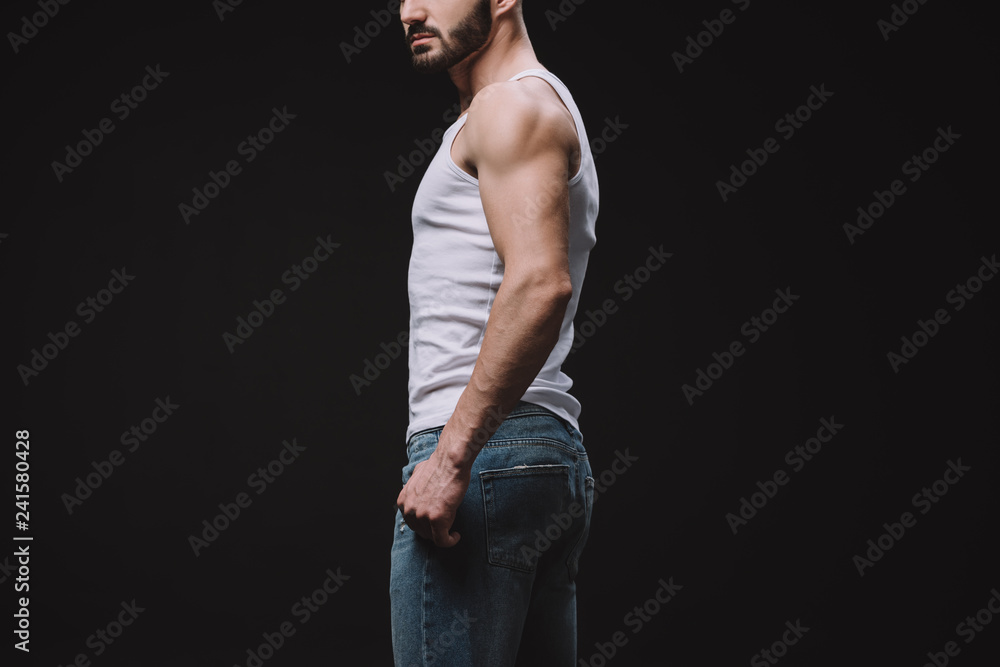 cropped view of macho posing in white singlet isolated on black cropped view of macho posing in white singlet isolated on black