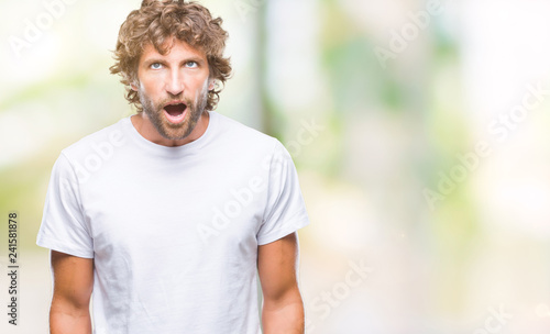 Handsome hispanic model man over isolated background afraid and shocked with surprise expression, fear and excited face.
