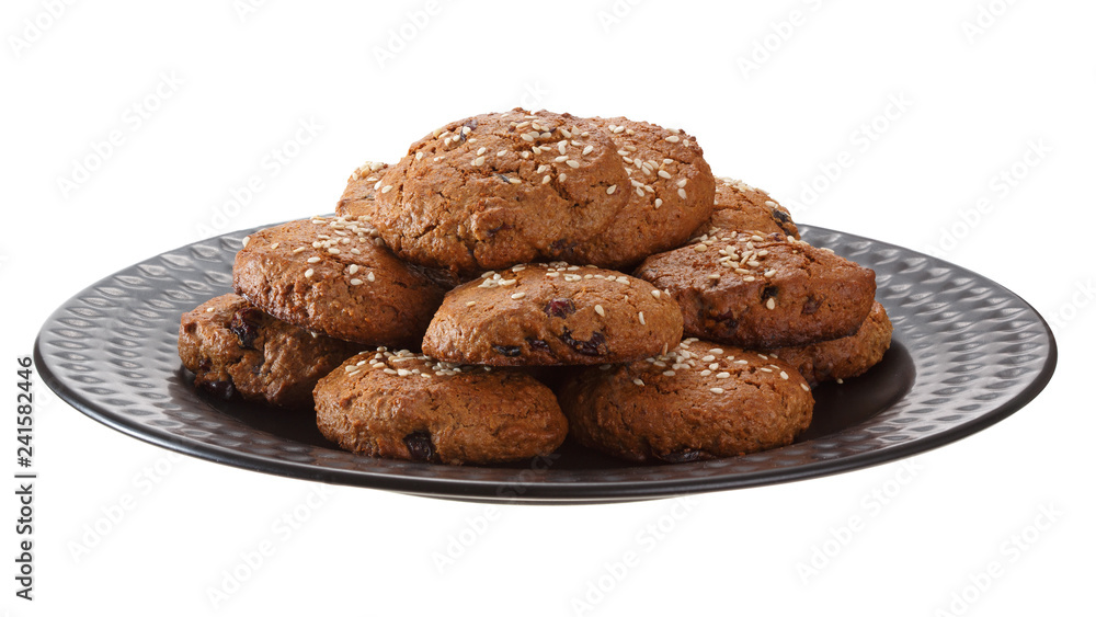 Fototapeta premium Homemade oatmeal cookies with nuts, chocolate chips and sesame. Isolated on white background.
