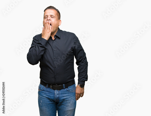Handsome middle age arab business man over isolated background bored yawning tired covering mouth with hand. Restless and sleepiness. © Krakenimages.com