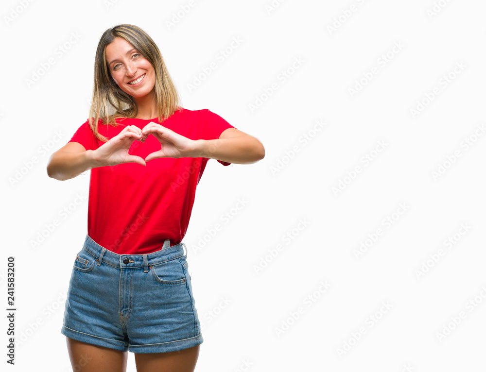 Young beautiful woman over isolated background smiling in love showing heart symbol and shape with hands. Romantic concept. Young beautiful woman over isolated background smiling in love showing heart symbol and shape with hands. Romantic concept.