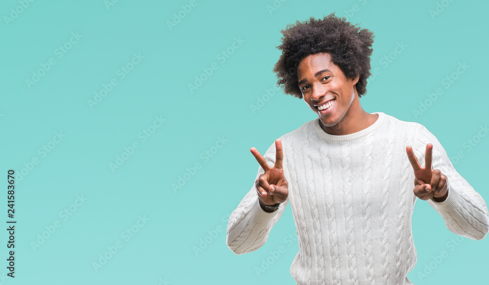 Afro american man over isolated background smiling looking to the camera showing fingers doing victory sign. Number two. Afro american man over isolated background smiling looking to the camera showing fingers doing victory sign. Number two.