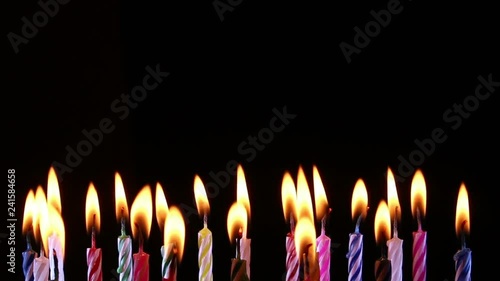 birthday candles light on isolated black