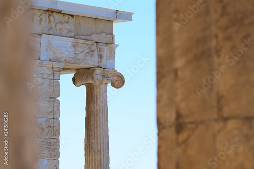 Ancient column with a classic Ionic capital against a blue cloudless sky at the temple of Athena Nike.