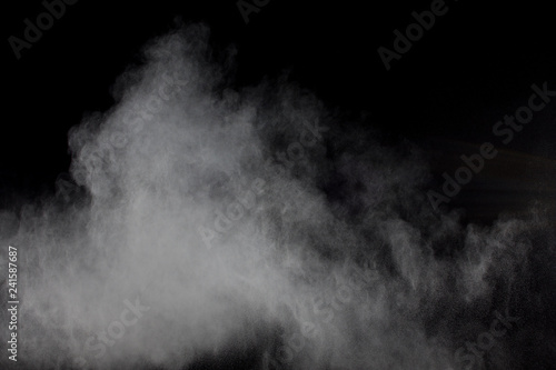 Abstract white powder explosion against black background.Abstract white dust exhale.