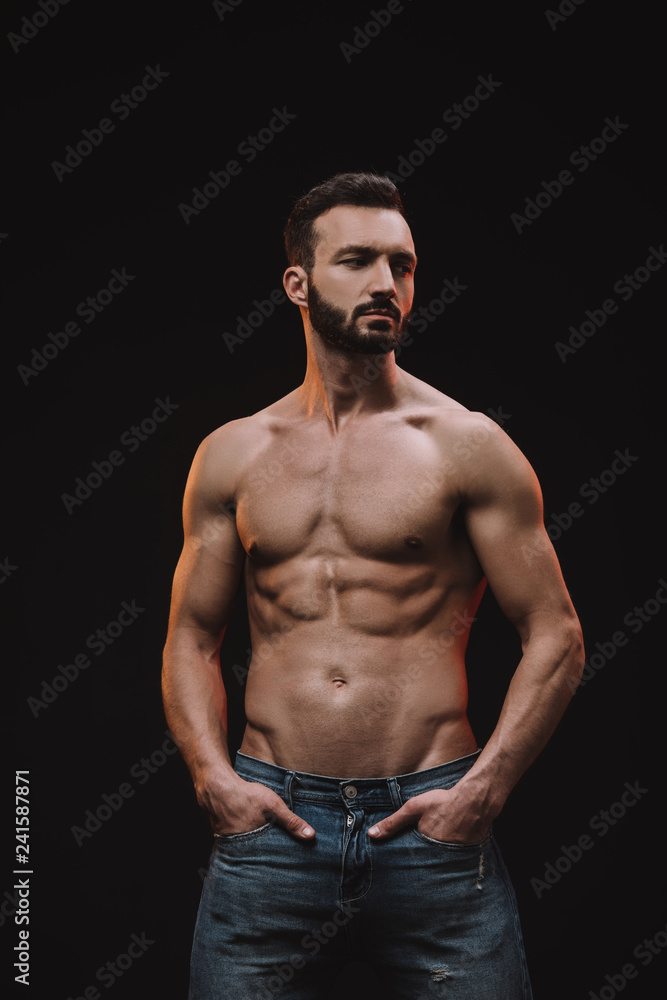 muscular shirtless macho posing isolated on black muscular shirtless macho posing isolated on black