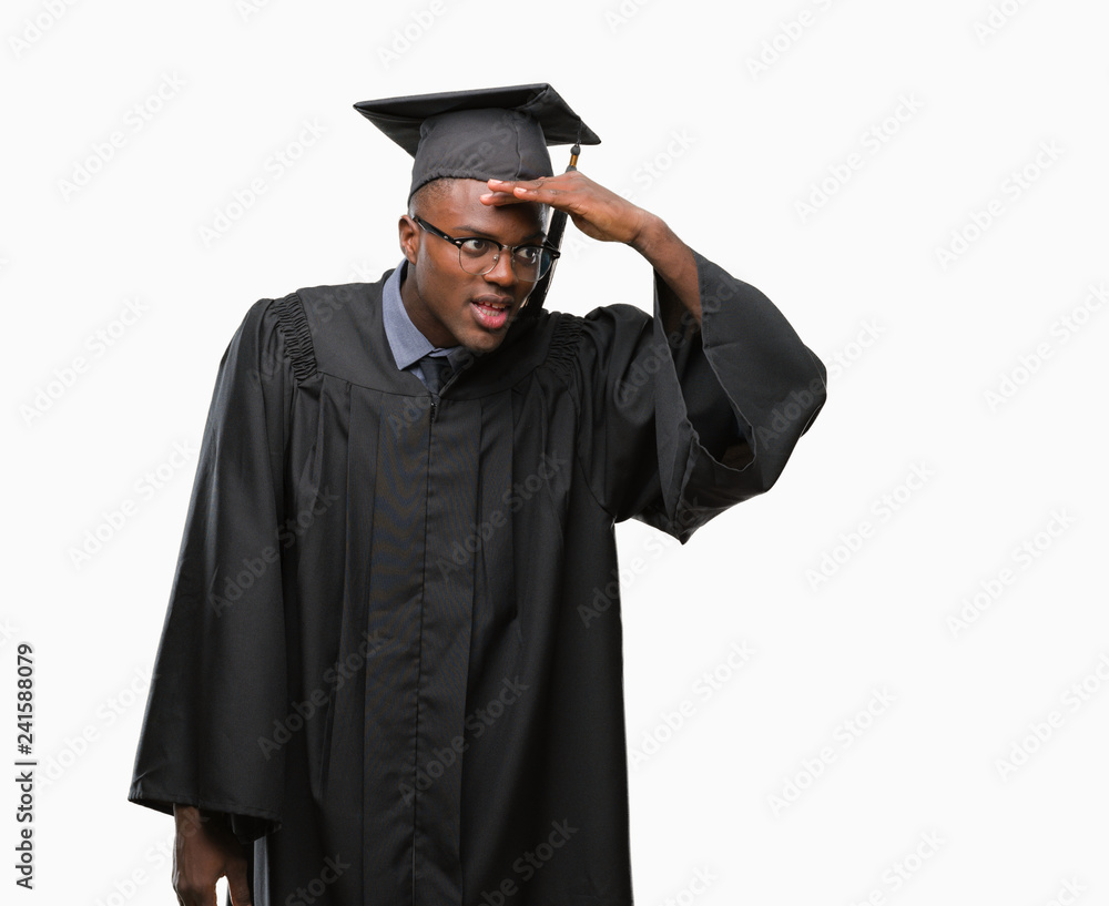 Young graduated african american man over isolated background very happy and smiling looking far away with hand over head. Searching concept. Young graduated african american man over isolated background very happy and smiling looking far away with hand over head. Searching concept.