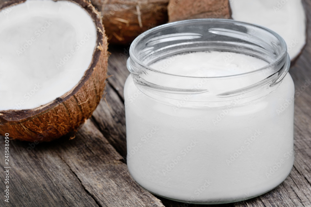 Coconut oil in a jar and fresh coconuts Coconut oil in a jar and fresh coconuts