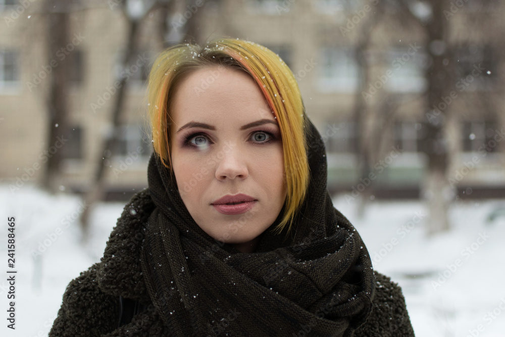 Portrait of a woman 30-40 years old with makeup on the street in winter. Portrait of a woman 30-40 years old with makeup on the street in winter.
