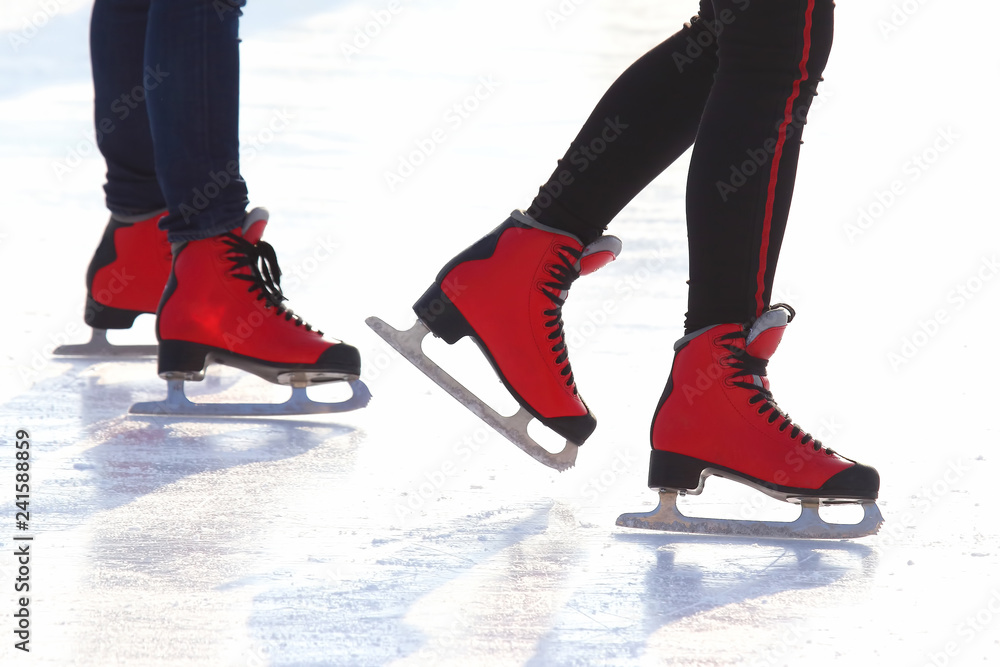 feet in red skates on an ice rink feet in red skates on an ice rink