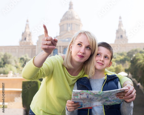 Young mother and son looking at map guide