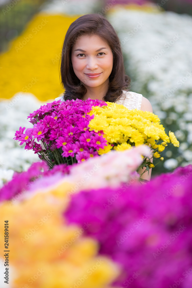 Beautiful Asian woman in tropical flower garden Beautiful Asian woman in tropical flower garden