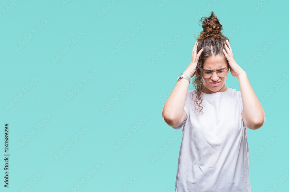 Beautiful young brunette curly hair girl wearing glasses over isolated background suffering from headache desperate and stressed because pain and migraine. Hands on head. Beautiful young brunette curly hair girl wearing glasses over isolated background suffering from headache desperate and stressed because pain and migraine. Hands on head.