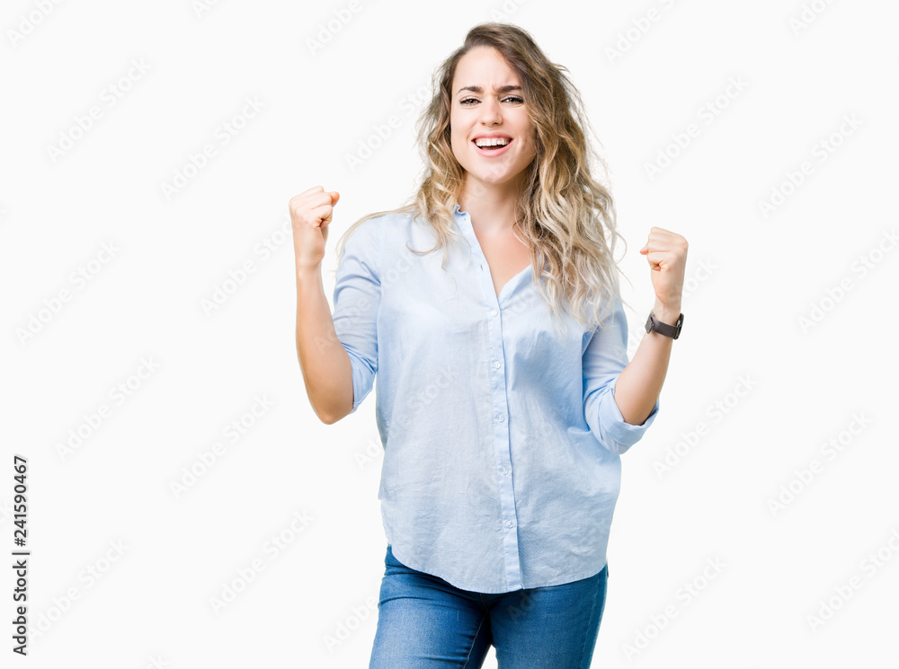 Beautiful young blonde business woman over isolated background celebrating surprised and amazed for success with arms raised and open eyes. Winner concept. Beautiful young blonde business woman over isolated background celebrating surprised and amazed for success with arms raised and open eyes. Winner concept.