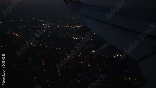 4K footage arial view of flying airlpane through the night light city scene London