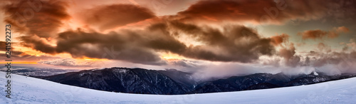 Mountains and snowstorm at sunset