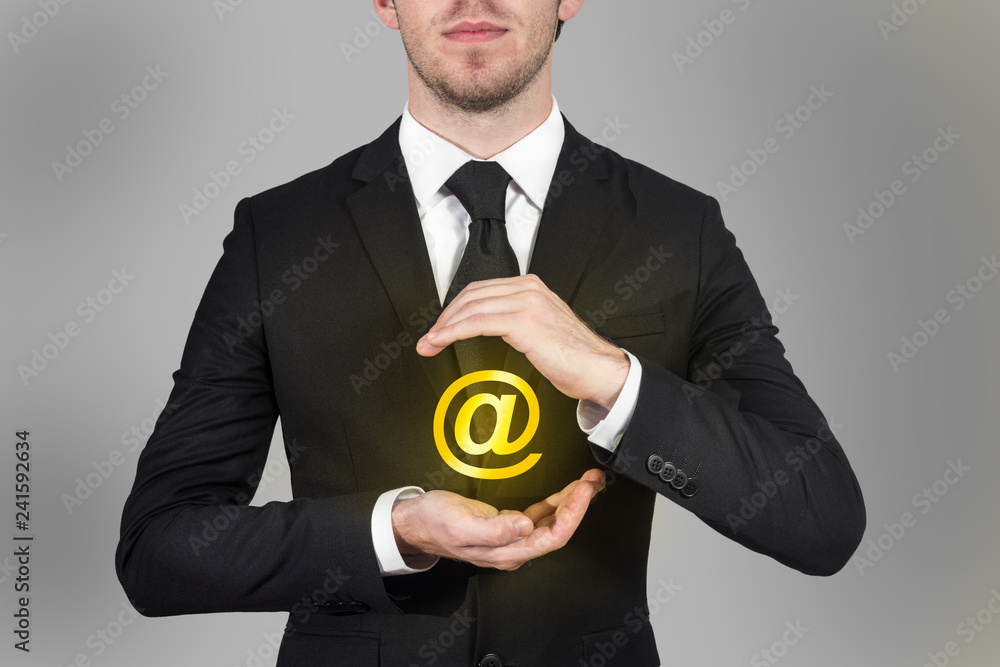 businessman in suit protects internet email symbol with his hands businessman in suit protects internet email symbol with his hands
