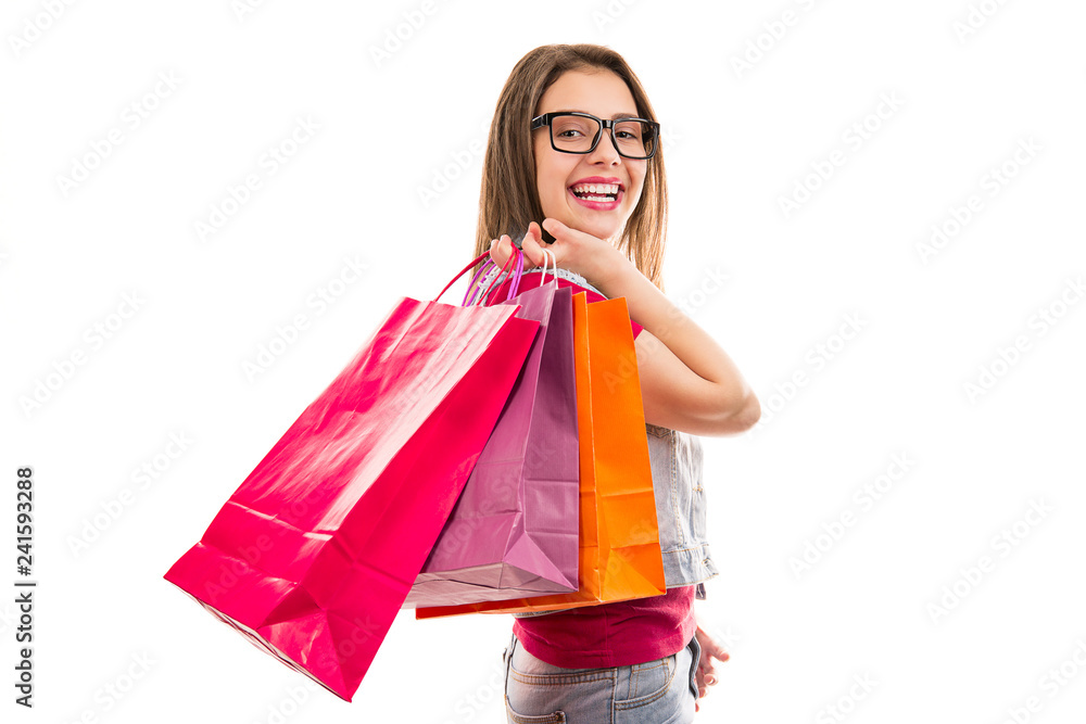 Smiling teenage woman with shopping bags