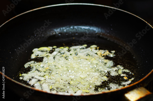 Frying chopped onions in a pan, cooking