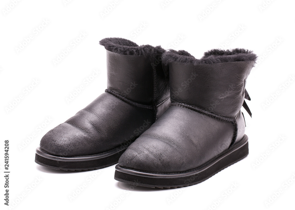 A pair of leather Australian Uggs on a white background. A pair of leather Australian Uggs on a white background.