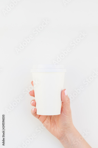 Mock up of coffee cup in female hand