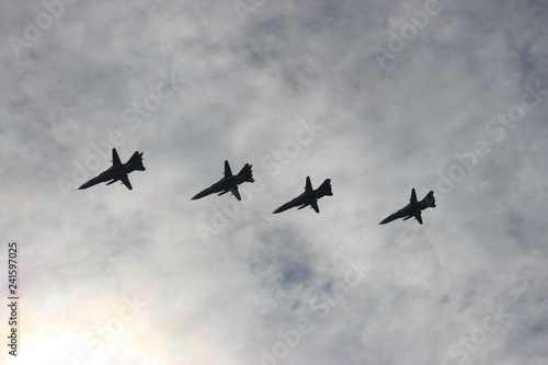planes in flight, against the cloudy sky