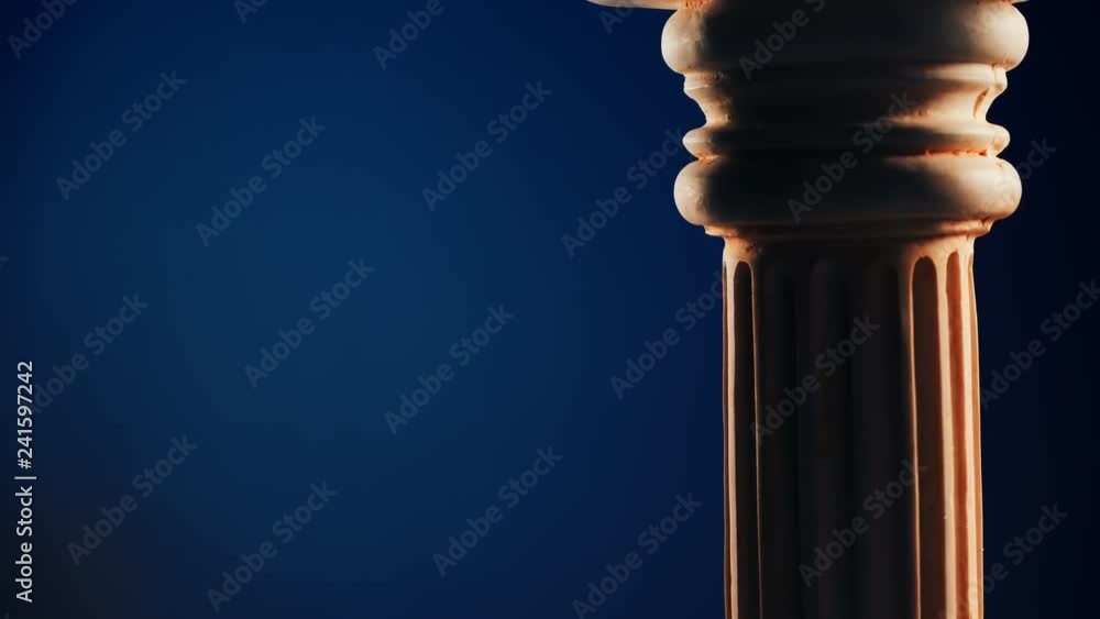 Single ancient greek column rotating slowly on dark blue background, copy space text area Single ancient greek column rotating slowly on dark blue background, copy space text area