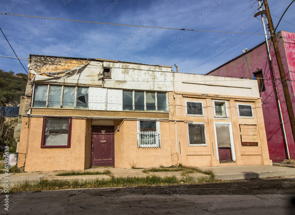 Side By Side Boarded Up Distressed Buildings In Need Of Repair
