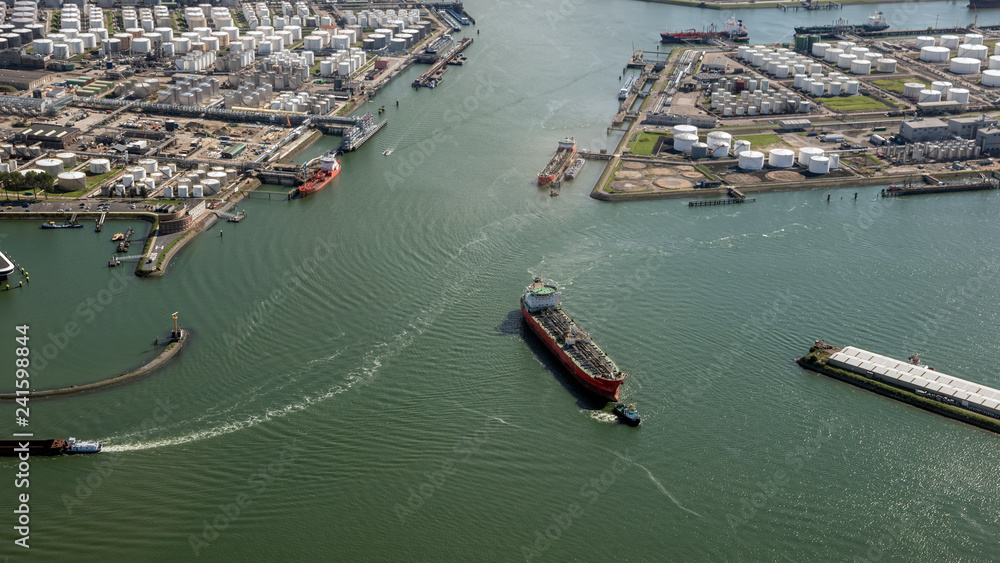 Aerial view of oil tankers moored at an oil storage silo terminal port