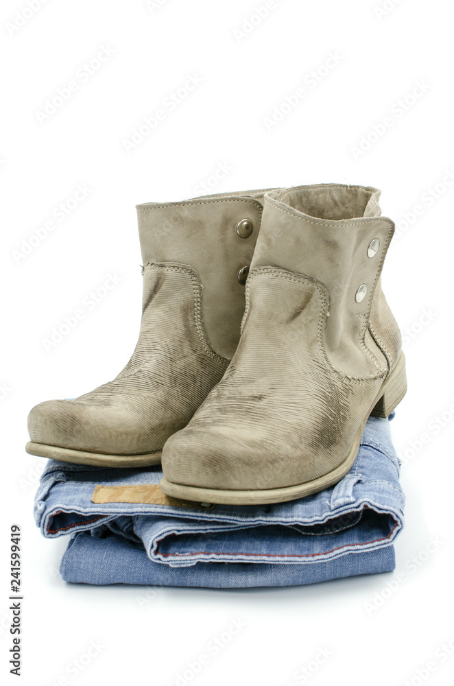 A pile of clothes with boots are on a white background A pile of clothes with boots are on a white background