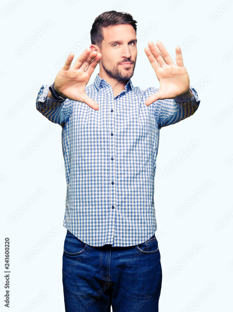 Handsome business man with blue eyes Smiling doing frame using hands palms and fingers, camera perspective Handsome business man with blue eyes Smiling doing frame using hands palms and fingers, camera perspective