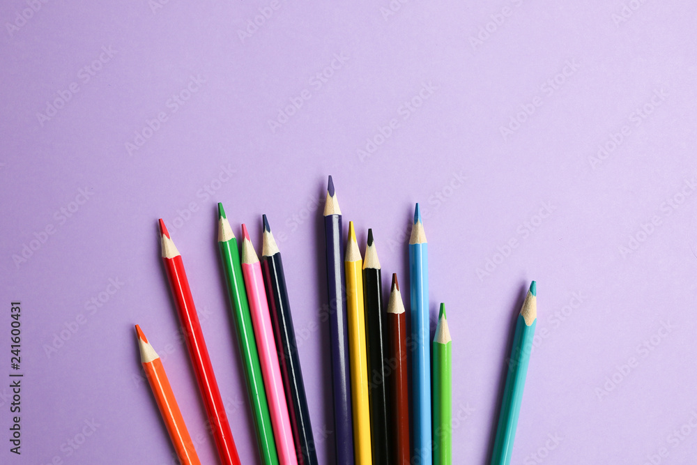 Color pencils lying on pastel purple background. Back to school concept. Colorful art studying and painting process. Drawing with pencils. Copy space place for postcard wish. Color pencils lying on pastel purple background. Back to school concept. Colorful art studying and painting process. Drawing with pencils. Copy space place for postcard wish.