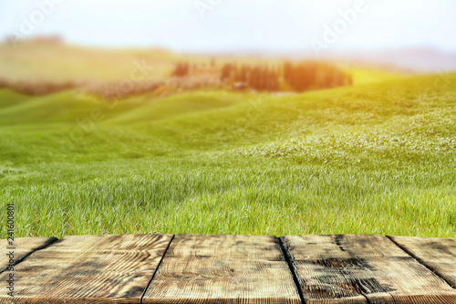 Fototapeta Naklejka Na Ścianę i Meble -  A wooden table with space for an advertising product in the spring day of beautiful Tuscany   