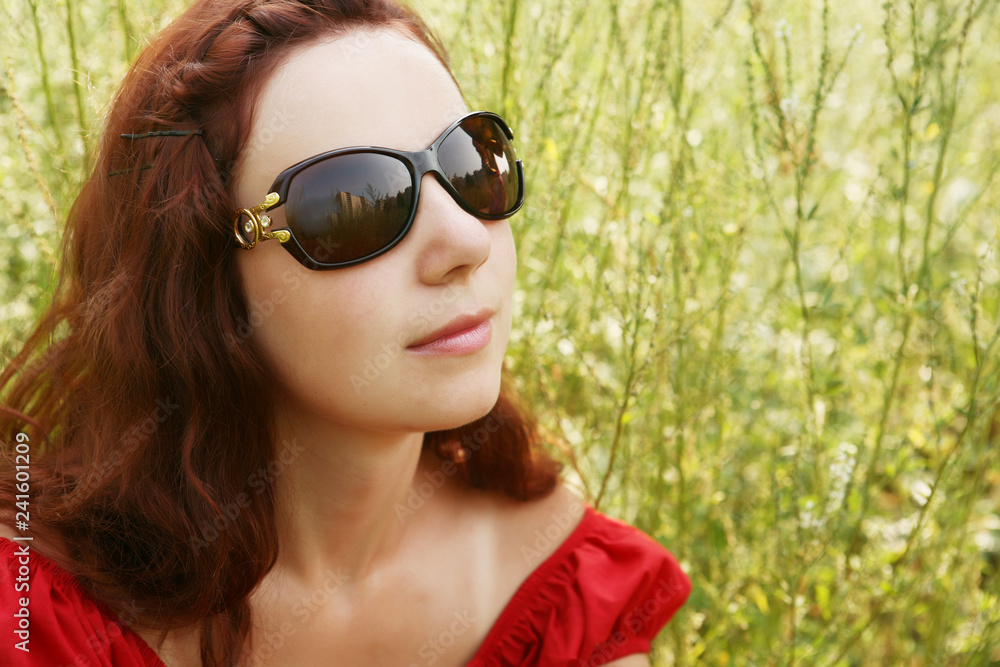 young woman relaxing in the grass young woman relaxing in the grass