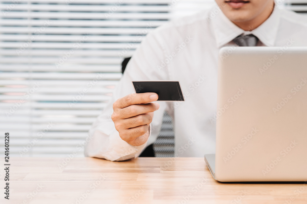 Businessman doing online banking, making a payment or buying a product on the Internet Businessman doing online banking, making a payment or buying a product on the Internet