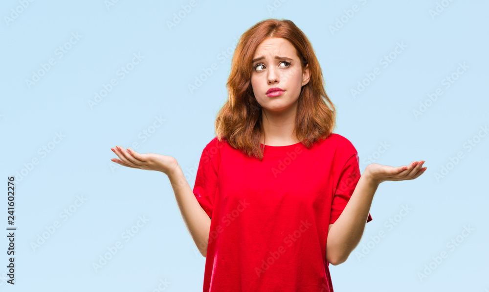 Young beautiful woman over isolated background clueless and confused expression with arms and hands raised. Doubt concept. Young beautiful woman over isolated background clueless and confused expression with arms and hands raised. Doubt concept.