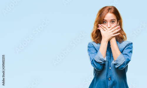 Young beautiful woman over isolated background shocked covering mouth with hands for mistake. Secret concept.