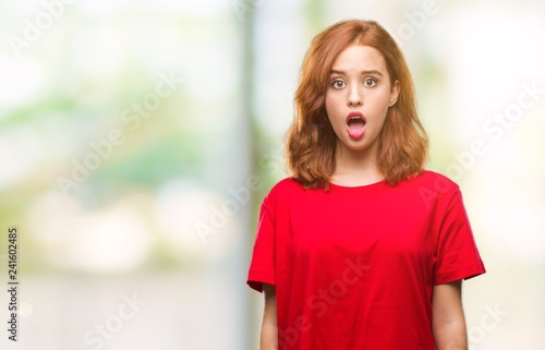 Young beautiful woman over isolated background afraid and shocked with surprise expression, fear and excited face. © Krakenimages.com