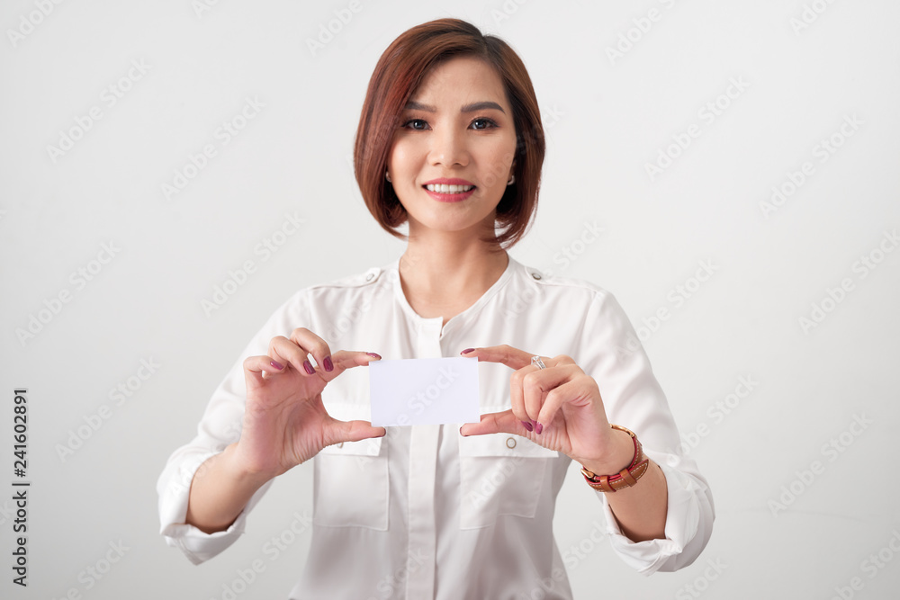 Young smiling asian woman holding a blank card, gesture isolated on white Young smiling asian woman holding a blank card, gesture isolated on white