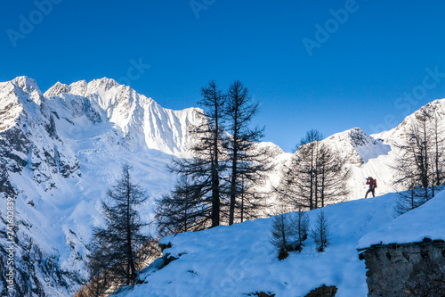 Photographer at the foot of snowy Monte Vazzeda, Alpe dell'Oro, Valmalenco, Valtellina, Sondrio province, Lombardy photo